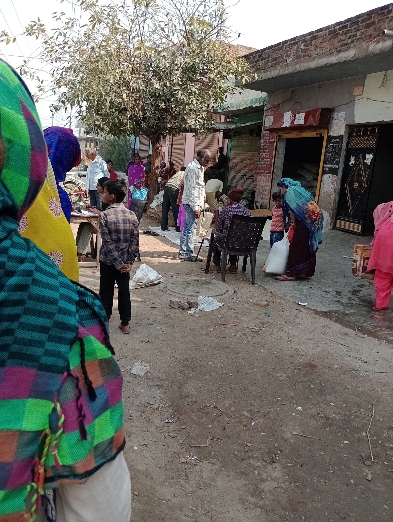 Families queuing outside a government ration retail shop in India
