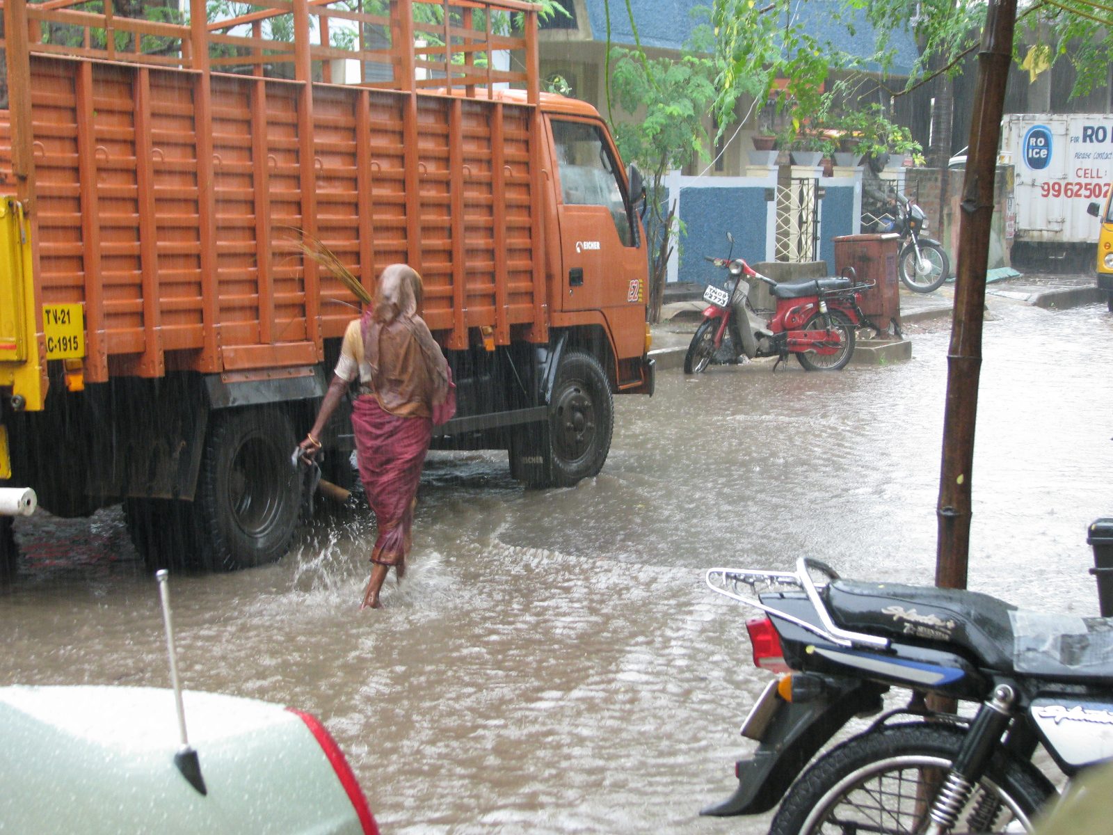 Dark monsoon clouds over a Chennai street during heavy rain