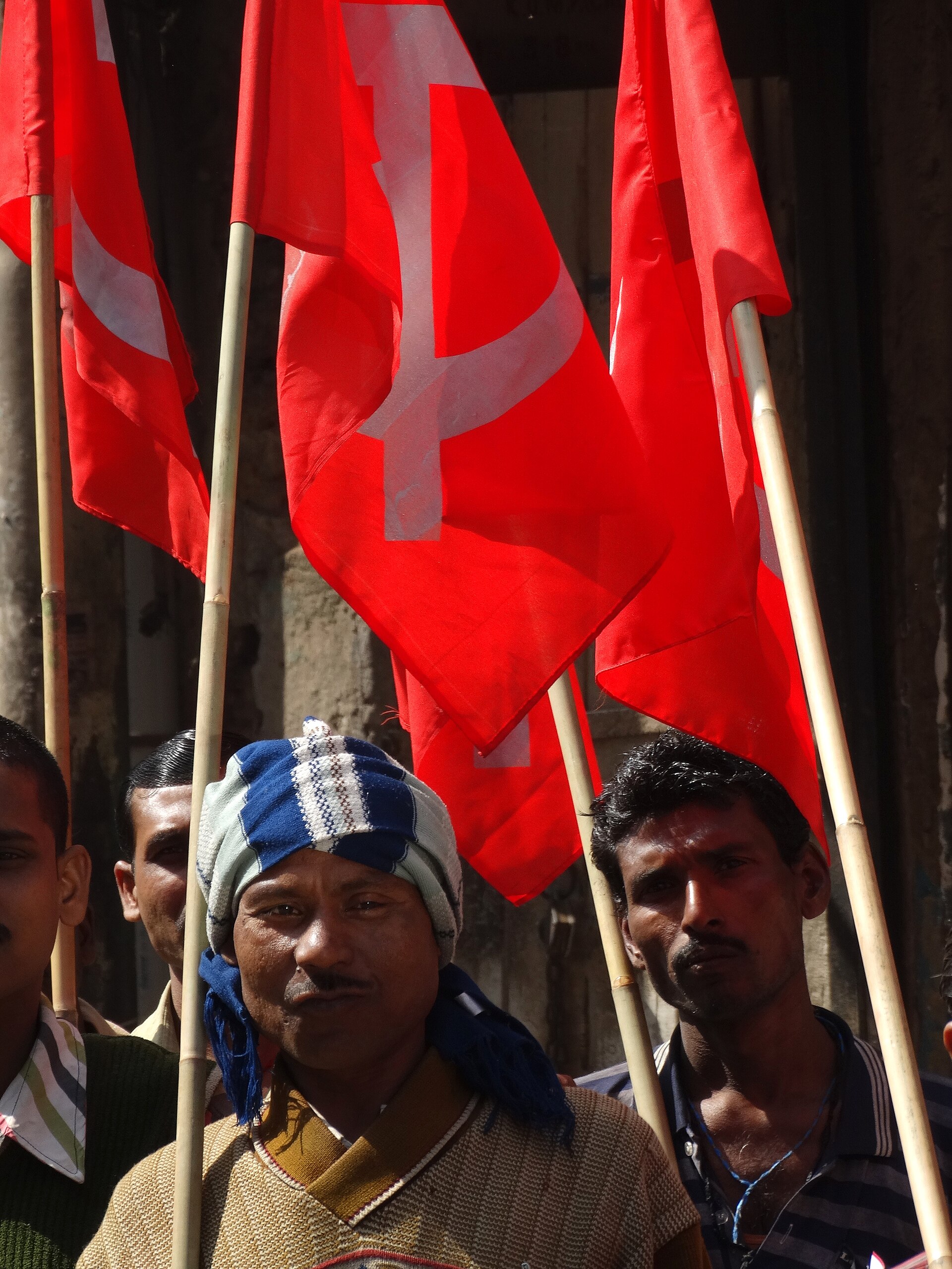 Communist demonstrators with hammer-and-sickle banners in Kolkata