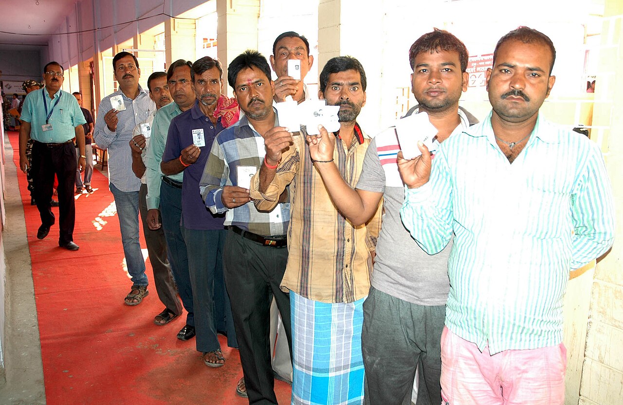 Voters queue at a polling booth during a Bihar assembly election in Gaya