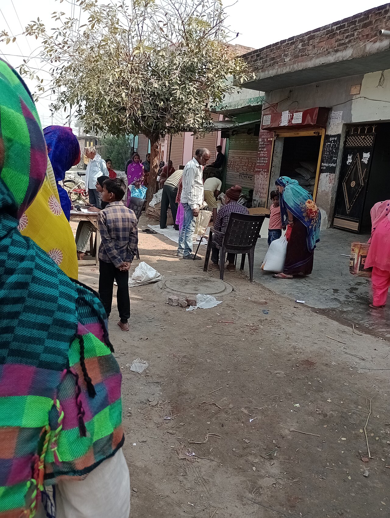 People queue at a government ration shop in India